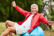 © Robert Kneschke - Senior man is kidding around with exercise ball