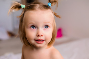 Wall Mural - Portrait of a toddler girl playing at home with her parents