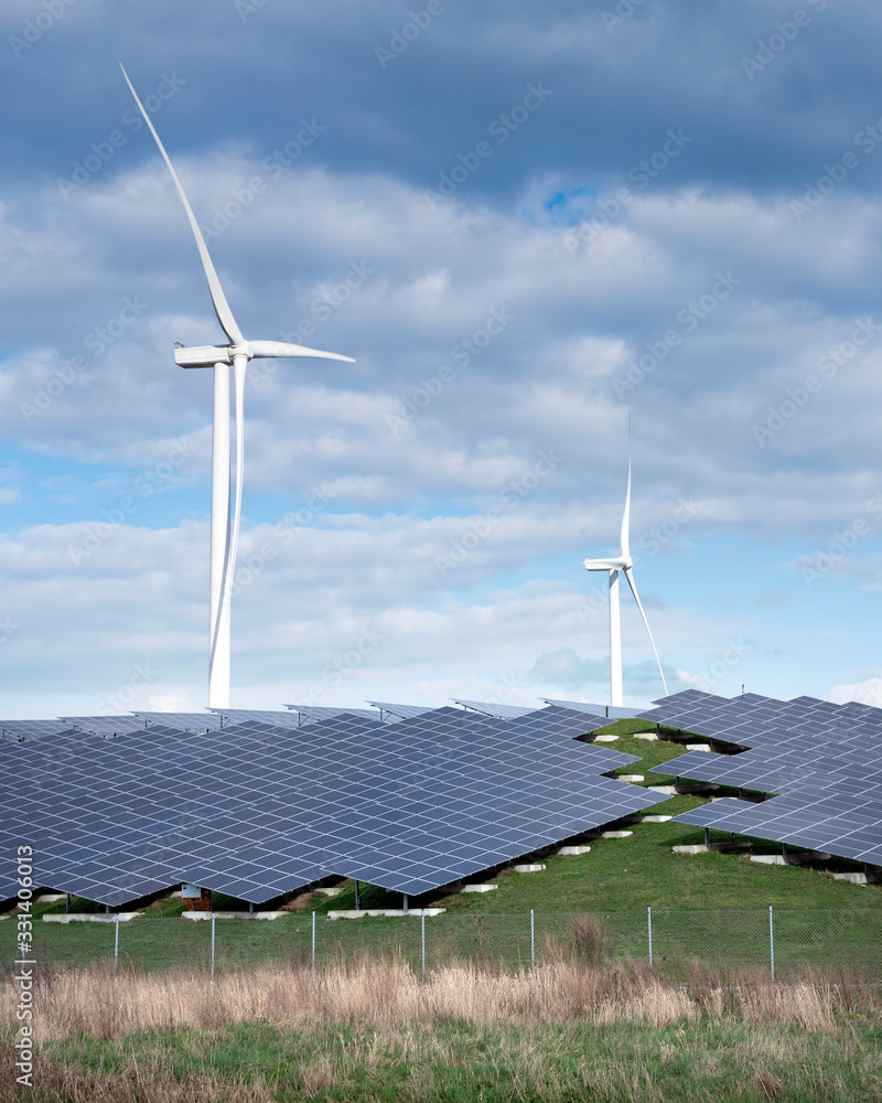 wind turbines and solar panels form alternative enery plant close ...