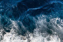 Top Down Aerial View Of Sea Water Surface. White Foam Waves Texture As Natural Background.