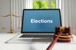 Elections – Law, Judgment, Web. Laptop in the office with term on the screen. Hammer, Libra, Lawyer.
