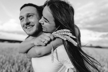 Wall Mural - Young couple in love outdoor.Stunning sensual outdoor portrait of young stylish fashion couple posing in summer in field