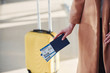 © standret - Close up view of woman that standing in the airport with tickets in hands