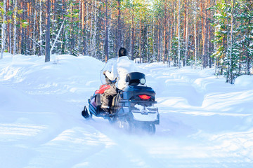 Wall Mural - Woman on Snowmobile at Winter Finland Lapland at Christmas