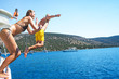 © IrynaV - Young couple diving into the turquoise water of the sea from yacht.