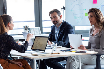 Business people discussing together in conference room during meeting at office.