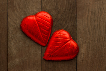 Red heart shaped two chocolate on the wooden table.Valentine's Day or any special day concept.