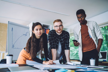 Sticker - Diverse adult employees working with new project in light office