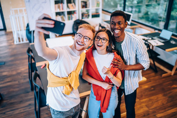 Poster - Diverse colleagues taking selfie in office