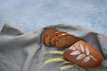 Sliced loaf of rye bread on rustic wooden background