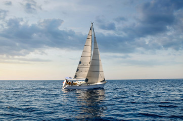 close-up sailboat sailing under a beautiful sunset