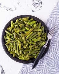 Wall Mural - Tasty fried green beans on a pan. Delicious green beans fired with spices. Vegetarian food, Diet food. Top view