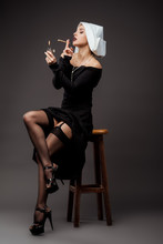 Sexy Nun In Stockings Smoking Marijuana Joint With Lighter On Grey