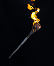 Wooden Burning Torch On A Black Background