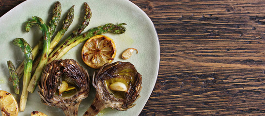 Wall Mural -  artichoke and asparagus grill. Tasty vegetables are first cooked for a couple, then fried on a grill, poured with olive oil and spices. spring vegetables. Flatlay.  copy space. top view