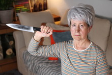 Senior Woman Holding A Knife