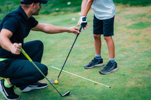 Golf – Personal Training. Golf Instructor Teaching Young Boy How To Play Golf.