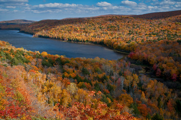 Wall Mural - Shafts of sunlight play across the fall colors on the shore of Lake of the Clouds in the Porcupine Mountains Wilderness State Park, Michigan.