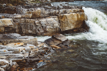 Wall Mural - stream of river among stones and rocks. stream in stone bed, fast mountain river among rocks, water 