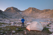 © SuperStock - Adult male wearing blue down jacket enjoying the view at backcountry camp in Indian Basin. Fremont and Jackson Peaks are in the distance. Bridger Wilderness.  Wind River Range Wyoming; Adult male wearing blue down jacket enjoying the view at backcountry camp in Indian Basin. Fremont and Jackson Peaks are in the distance. Bridger Wilderness.  Wind River Range Wyoming. Wyoming. United States