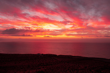 Wall Mural - Beautiful colourful sunset above Atlantic ocean and coast, horizon over water, Playa de sotavento, Fuerteventura, Spain 