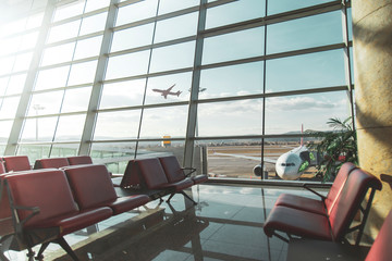 An empty terminal, aircrafts are waiting and preparing for their next flight and one of them taken off