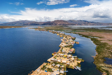 Wall Mural - Aerial view of Uros Floating Islands on Titicaca Lake, the highest navigable lake in the world, near Puno, Peru, South America.