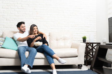 Happy Couple Is Watching TV At Home