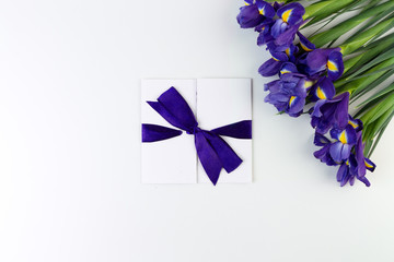 Wall Mural - Gift card and Lovely iris flowers isolated on white backdrop, holiday postcard with copy space. Gift mockup.