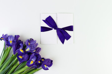 Wall Mural - Gift card and Lovely iris flowers isolated on white backdrop, holiday postcard with copy space. Gift mockup.
