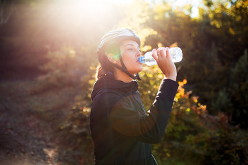 Professional female cyclist drinking water