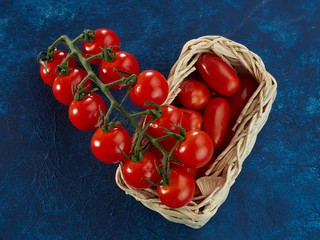 Sweet ripe cherry tomatoes lie against a classic blue background.Red.Blue.Healthy food.Fresh vegetable