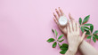 © Miha Creative - Natural Cosmetics for hand skin care with cream bottle, a means to reduce wrinkles on hands, moisturizing. Beautiful woman's hands on the pastel  pink background.