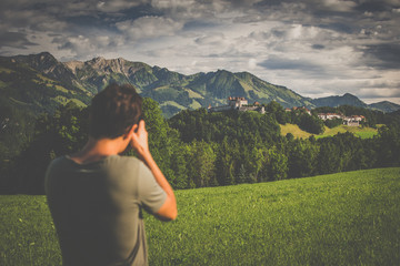 Wall Mural - Photographer taking photos of the splendid medieval village of Gruyères, Switzerland