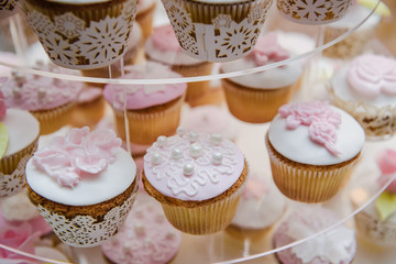 Wall Mural - Luxurious pink wedding cake with flowers. Birthday, Valentine's day cake. Cupcakes with pink roses. Wooden background