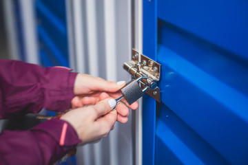 View of self storage warehouse interior, process of keeping and storing the goods and items in storage units, self-storage building, lock and key concept