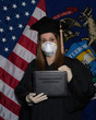 © Bethany - College graduate student wears mask gloves cap gown for commencement ceremony that is postponed or cancelled due to coronavirus COVID-19 outbreak and social isolation