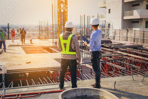 Fotografía Structural engineer and foreman worker with touch pad discuss, plan working for the outdoors building construction site