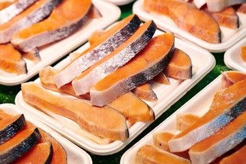 Wall Mural - Frozen salmon on plastic tray 