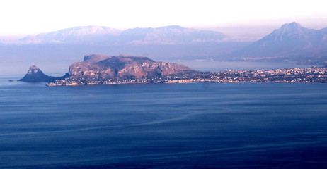 evocative image of sea coast with promontory on the background in sicily, italy