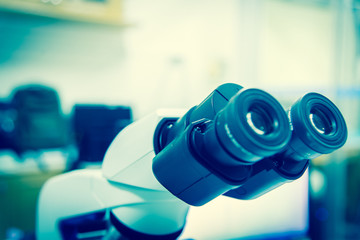 Close up lens microscope in laboratory.