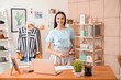 © Pixel-Shot - Portrait of female clothes stylist in office