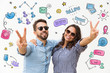 © Mangostar - Relaxed carefree couple with hand drawn social media sketches. Pair making victory gesture, celebrating vacation. Young woman and man in casual and sunglasses. Holiday or peace sign concept