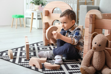 Wall Mural - Little boy playing with take-apart house at home