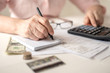 © shumytskaya - Pension calculation concept, old hands counting finances on a home calculator , close- up