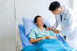 © Nipapun - Close-up of Young male Asian doctor physician listening to action patient lie in bed  heartbeat or breathing patients in the hospital/ Healthcare and medically concept.