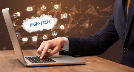 businessman working on laptop with high-tech inscription, modern technology concept