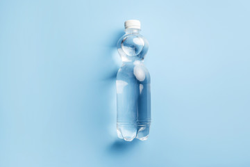 Wall Mural - Plastic water bottle on blue background