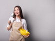 © LumenSt - Young woman in an apron with fresh bread on a gray background. Cook concept