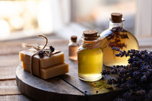 Concept Of Natural Organic Oil In Cosmetology. Moisturizing Skin Care And Aromatherapy. Gentle Body Treatment. Handmade Soap. Atmosphere Of Harmony Relax. Wooden Background, Lavender Flower Copy Space